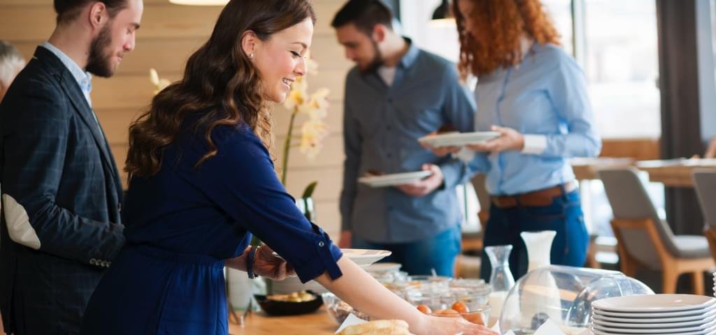 Young people at a breakfast buffet.