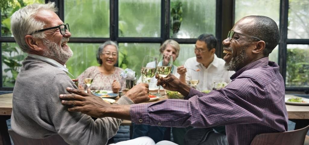 Multiracial group enjoying a meal.