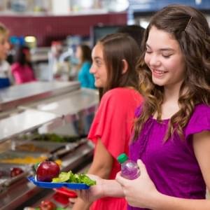 Students in a school cafeteria serving line.