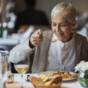 A woman eating dinner.